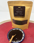 Od Achola Highland Black Kenyan black tea in a kraft pouch beside a dish of loose CTC tea and a wooden scoop